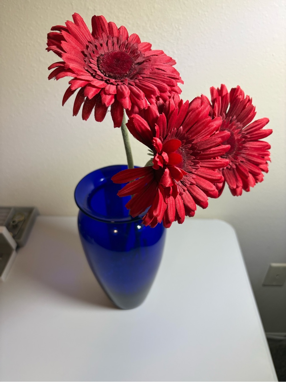 Unbranded Red Gerbera Silk Stems in Blue Glass Vase